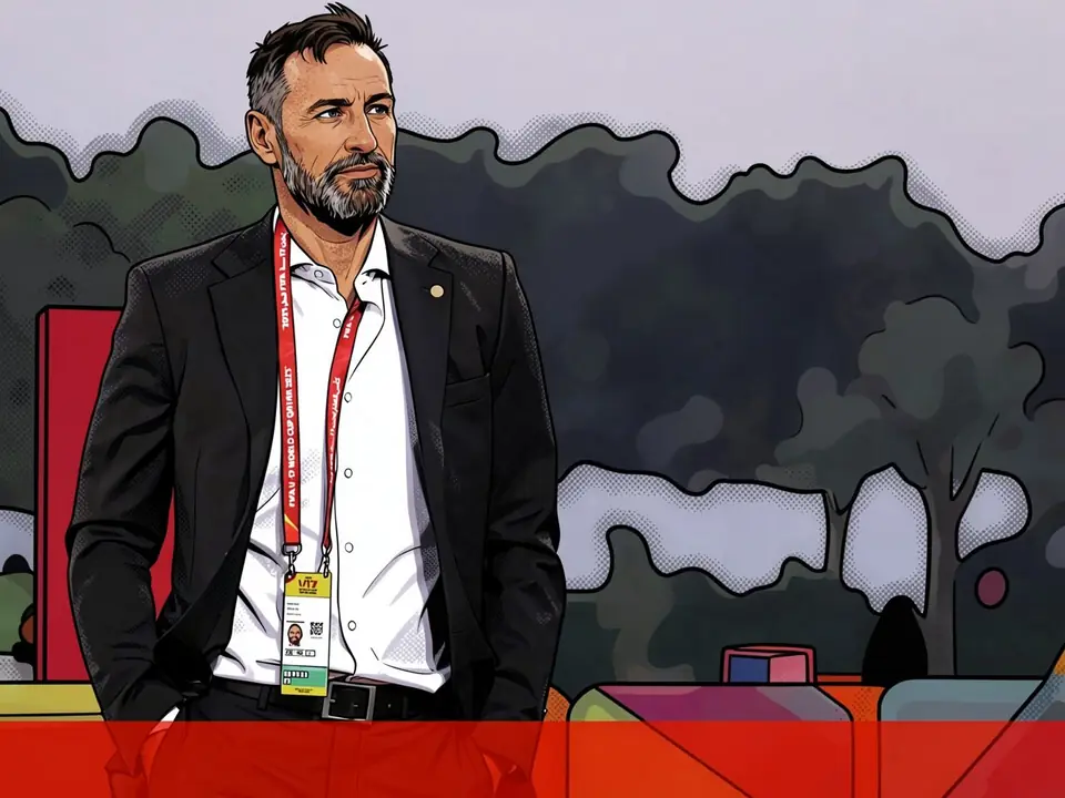 A man in a black suit and white shirt with a red FIFA U-19 badge stands against a stadium background