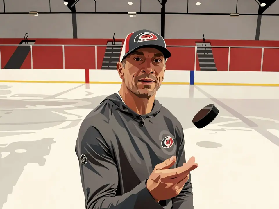 Brind′Amor in Carolina training gear tossing a puck on the ice