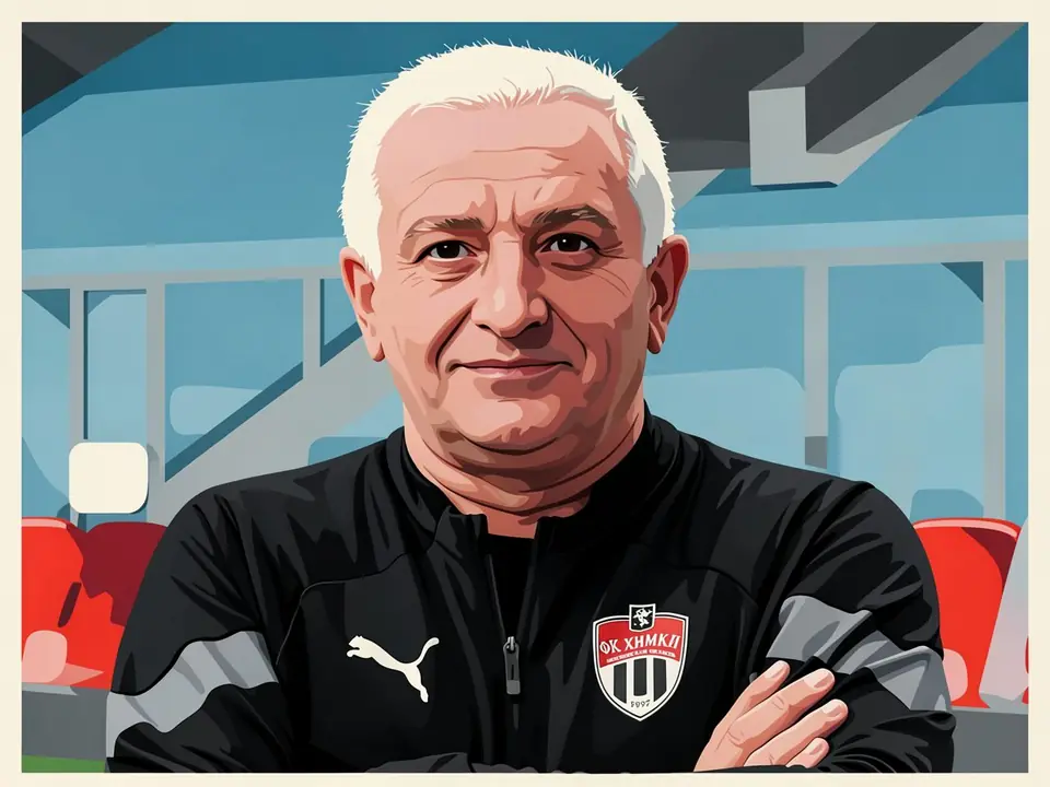 Hasan Dzhioev, coach of Khimki, stands with arms folded in front of stadium seats.