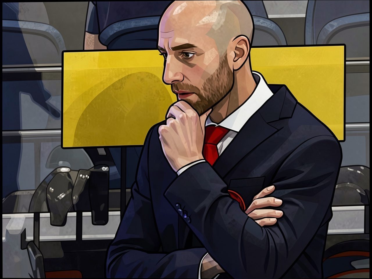 A bearded coach in a dark suit and red tie sits on the bench, resting his chin thoughtfully on his fist.