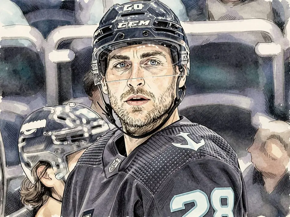 Defenseman Sousa in Islanders uniform sits on the bench. Black jersey with number 28, anchor logo on the shoulder.