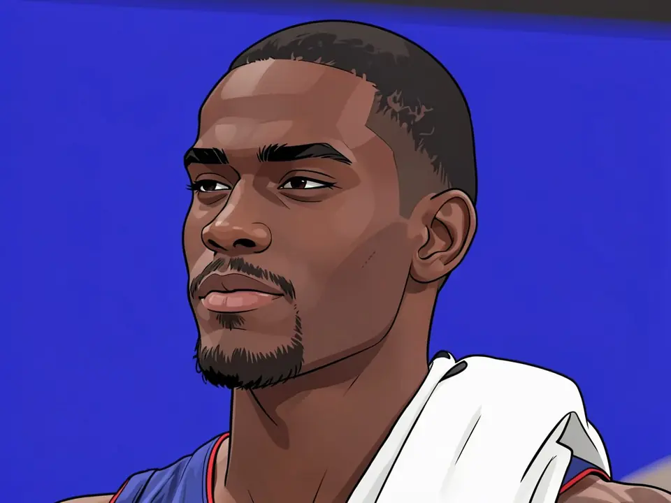 Jalen Duren in a blue Pistons jersey with a white towel over his shoulder.