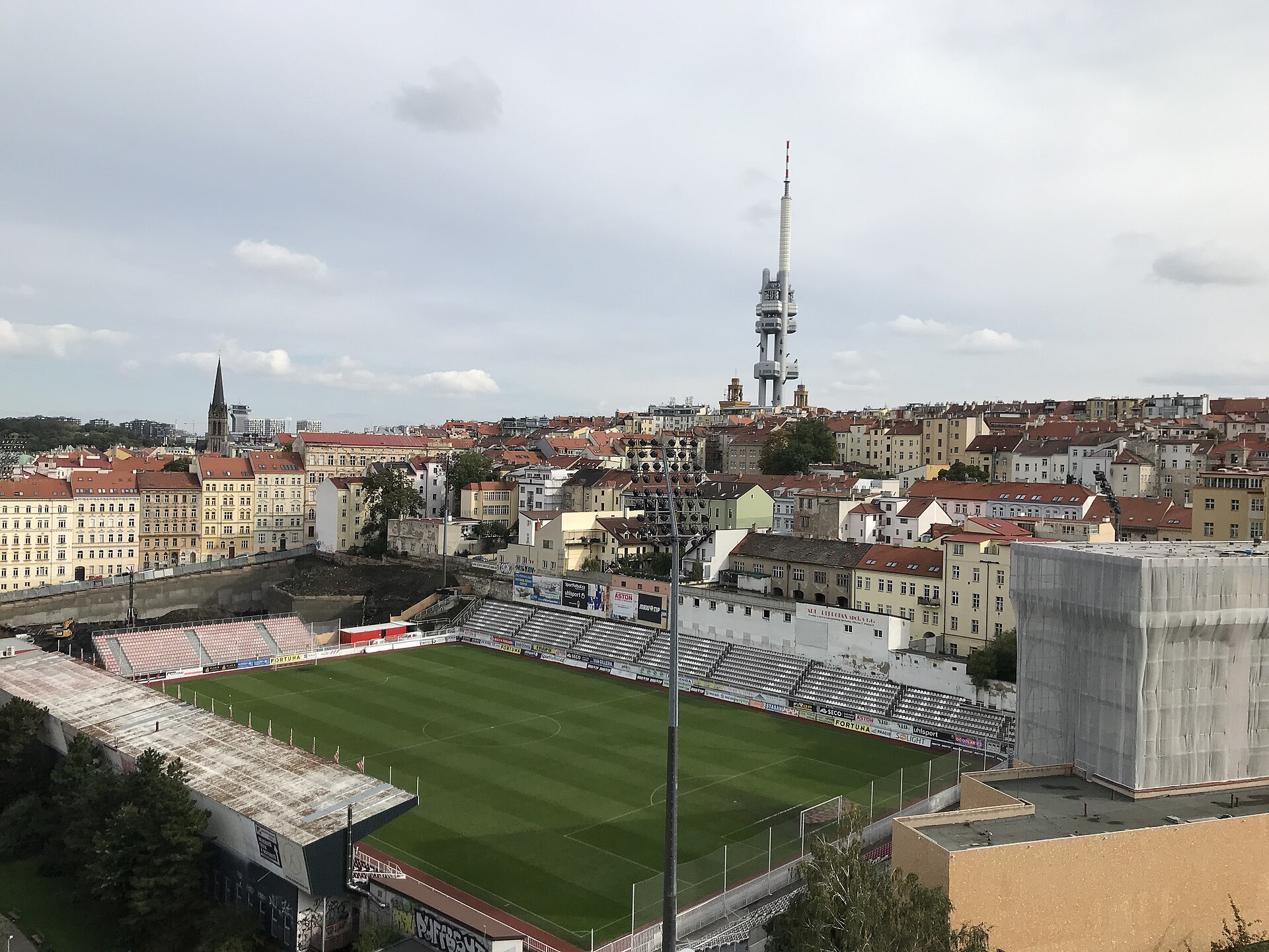 Stadion FK Viktoria Žižkov viewed from dům Radost terrace and Žižkov district with a Žižkov TV Tower in the background