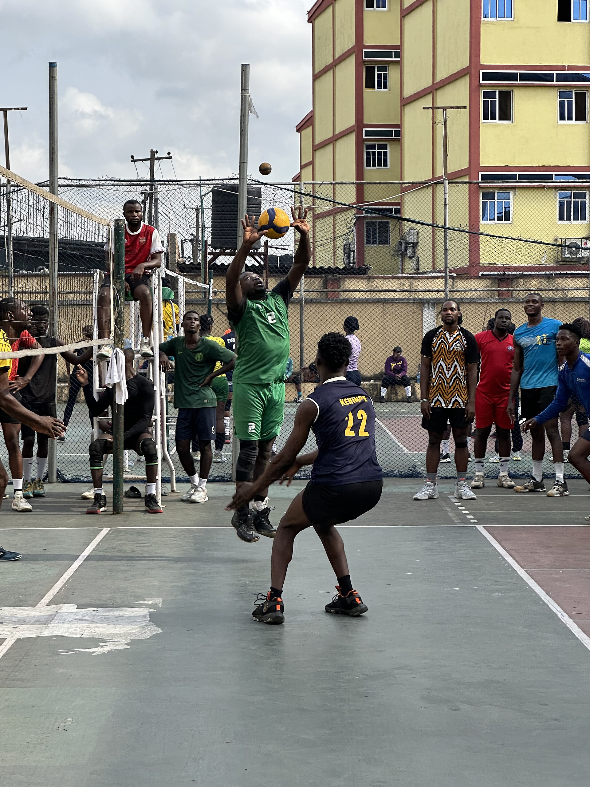 Players competing in an outdoor volleyball match at a private sports court in Lagos