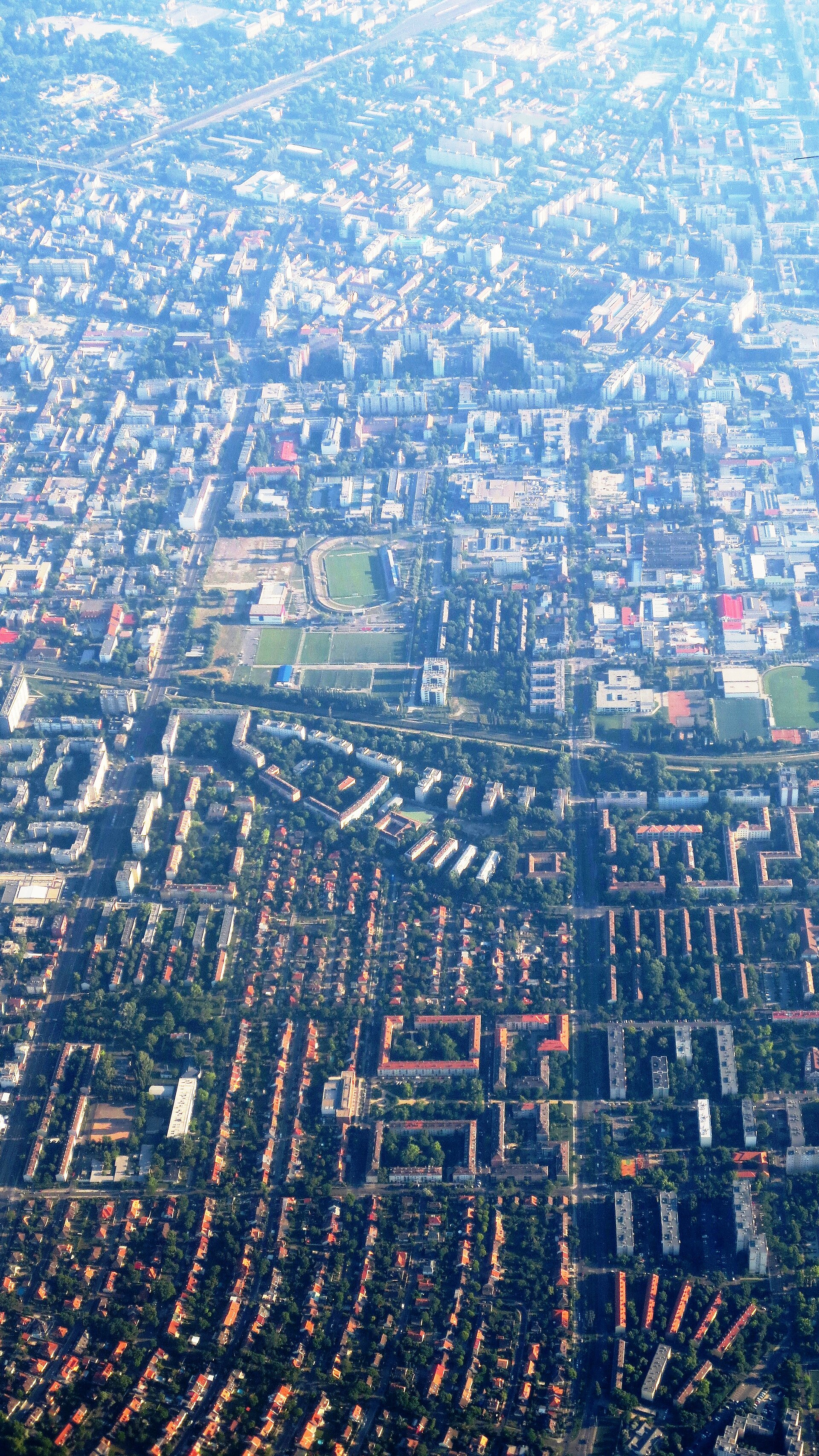Aeral view towards the south, over the Angyalföld quarters of District XIII, Budapest. The stadium is the Rudolf Illovzsky Stadium (Vasas SC). Note: remodelled in 2019