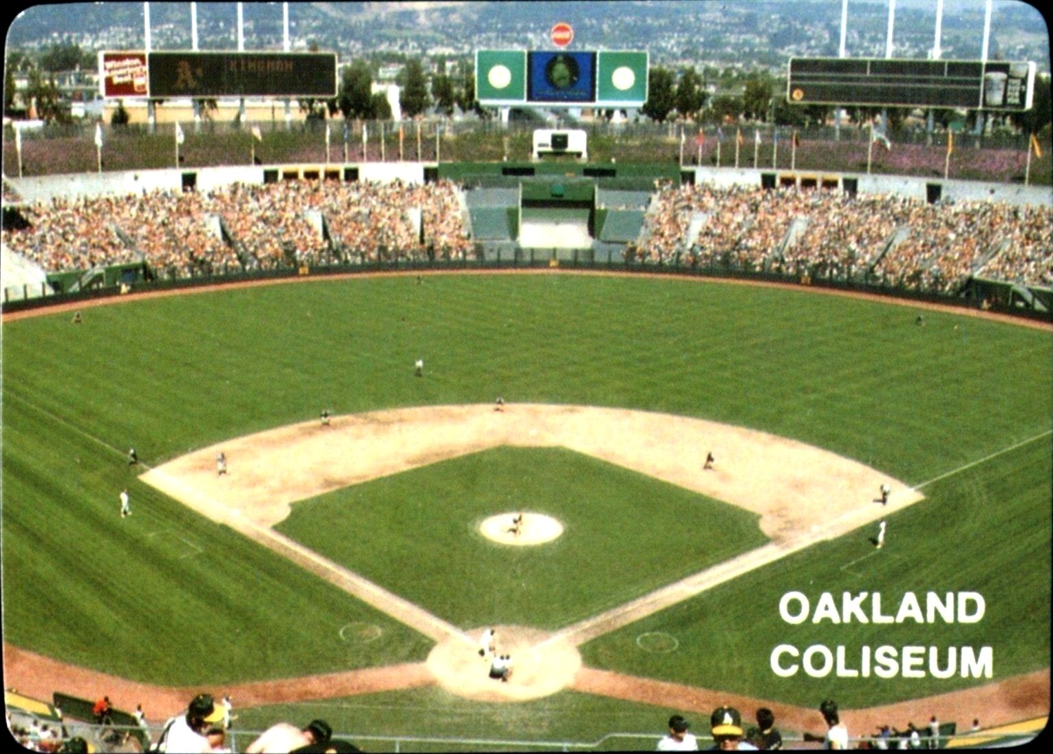 The checklist card of the 1985 Mother's Cookies Oakland Athletics trading cards set. An interior photograph of the Oakland Coliseum during an Athletics baseball game appears on the front of the card and a checklist of all 28 of the trading cards in the set appears on the back. The card is numbered #