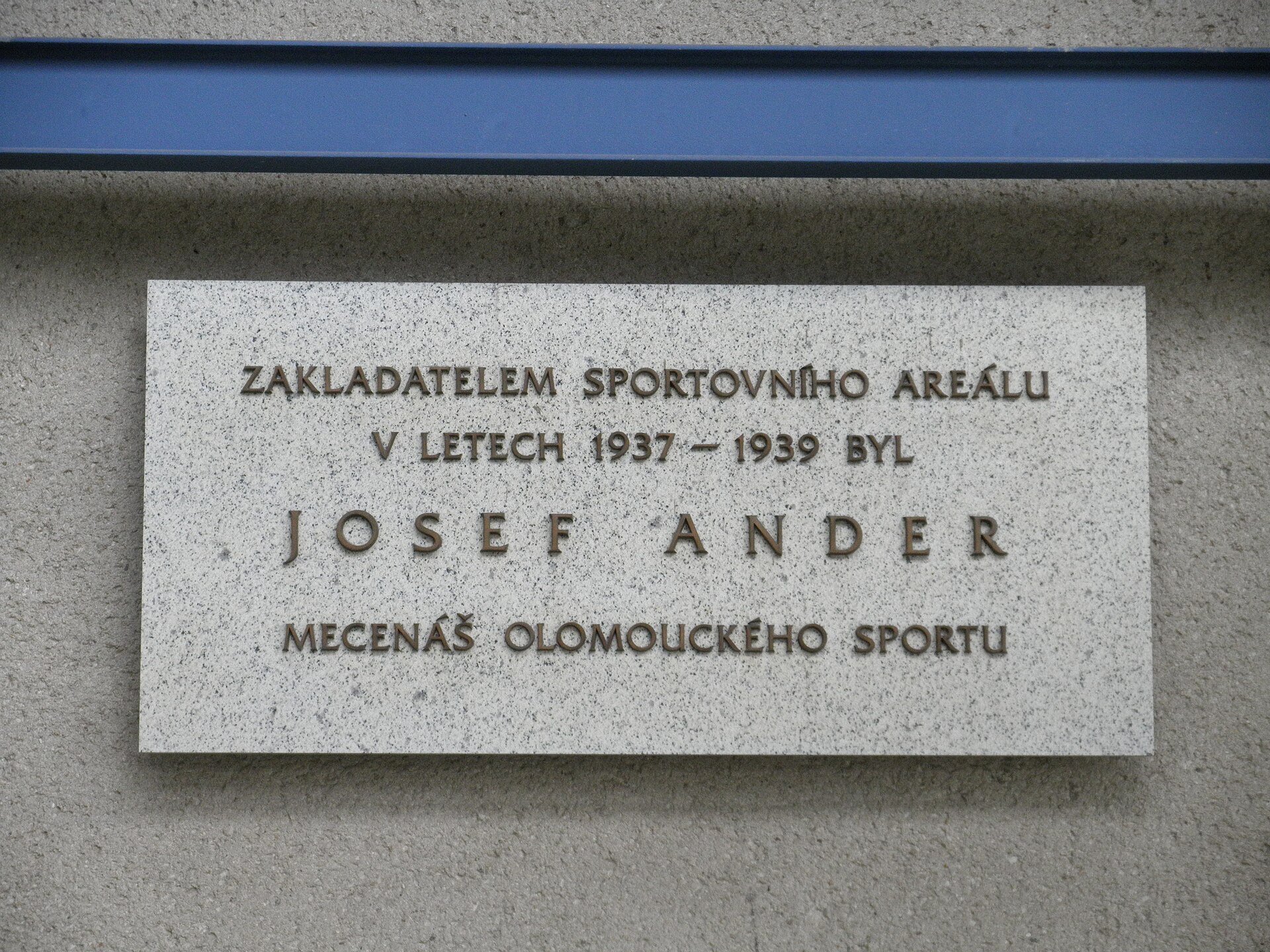 Memorial plaque of Josef Ander at 1165/12 Legionářská street, Olomouc, 49°36'1.509"N, 17°14'50.905"E. There is written on the plaque in the Czech language: The founder of the sporting area was in 1937-1939 Josef Ander patron of sport in Olomouc