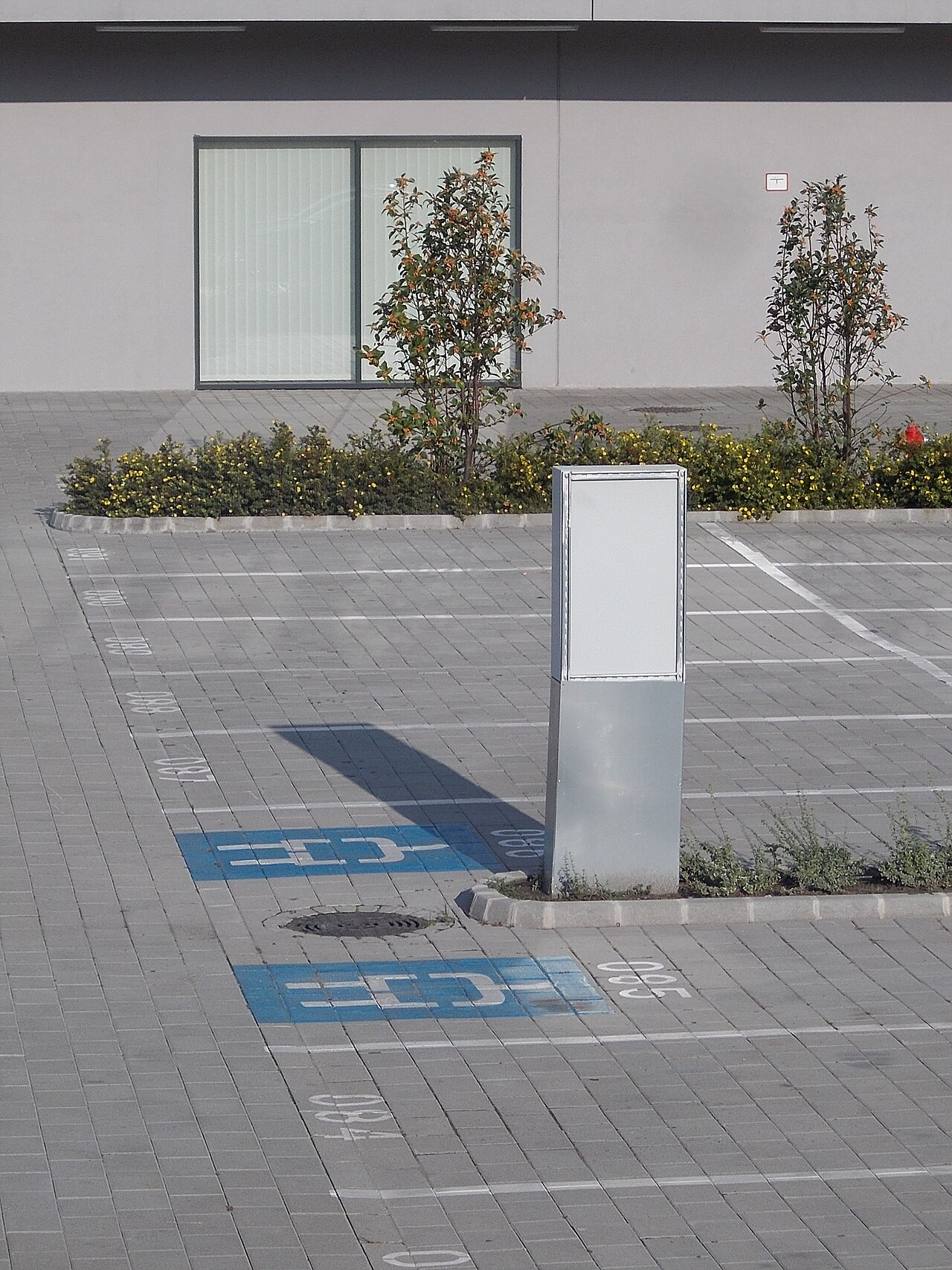 : Hidegkuti Nándor Stadion car park, electric vehicle parking road markings. Charging station too? - Salgótarjáni street, Százados neighborhood, Józsefváros district, Budapest .
