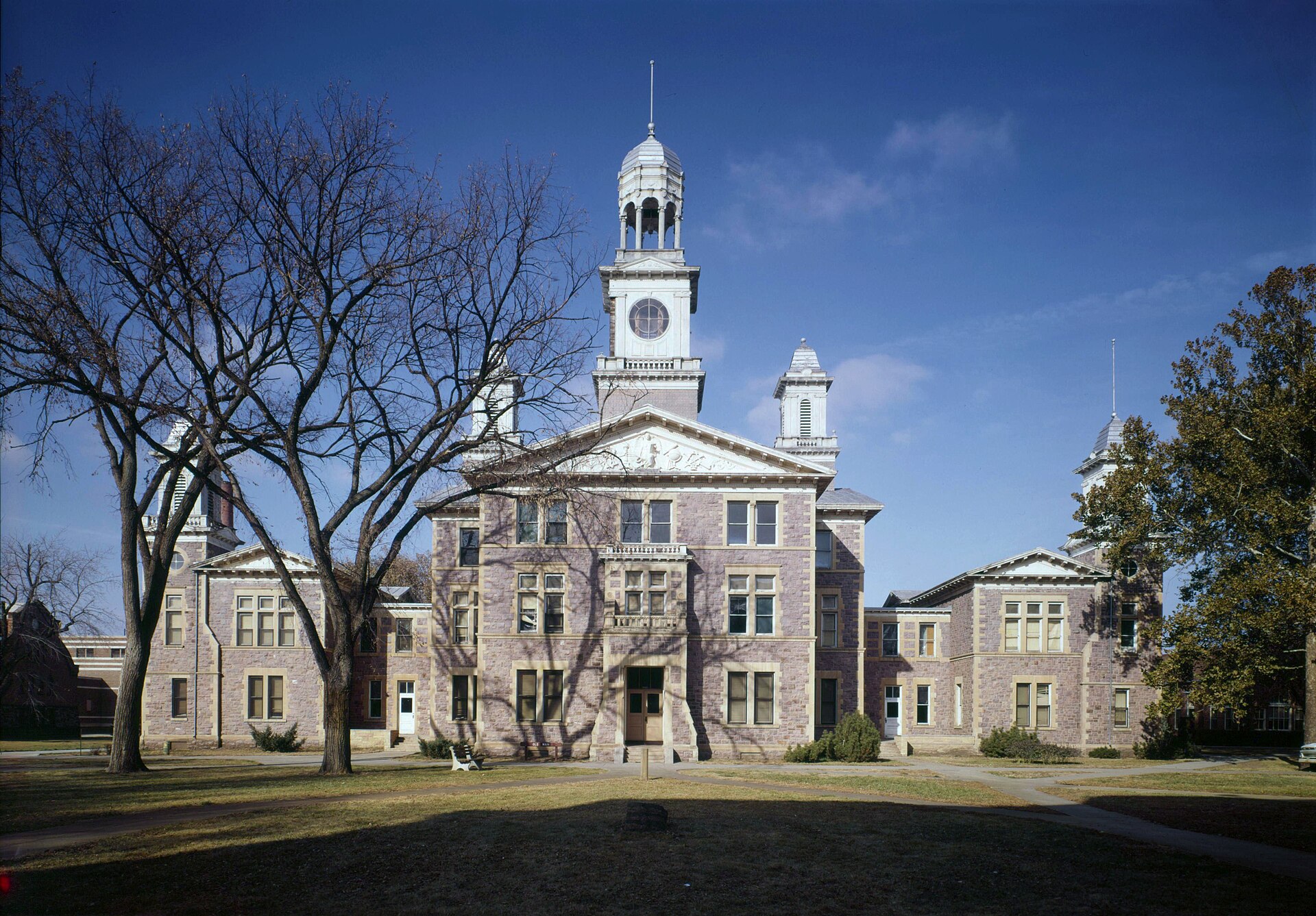 Front of Old Main (University Hall) — on the campus of the University of South Dakota in Vermillion , South Dakota , United States. Built in 1883, it is listed on the National Register of Historic Places . 1976 image: HABS−Historic American Buildings Survey of South Dakota .