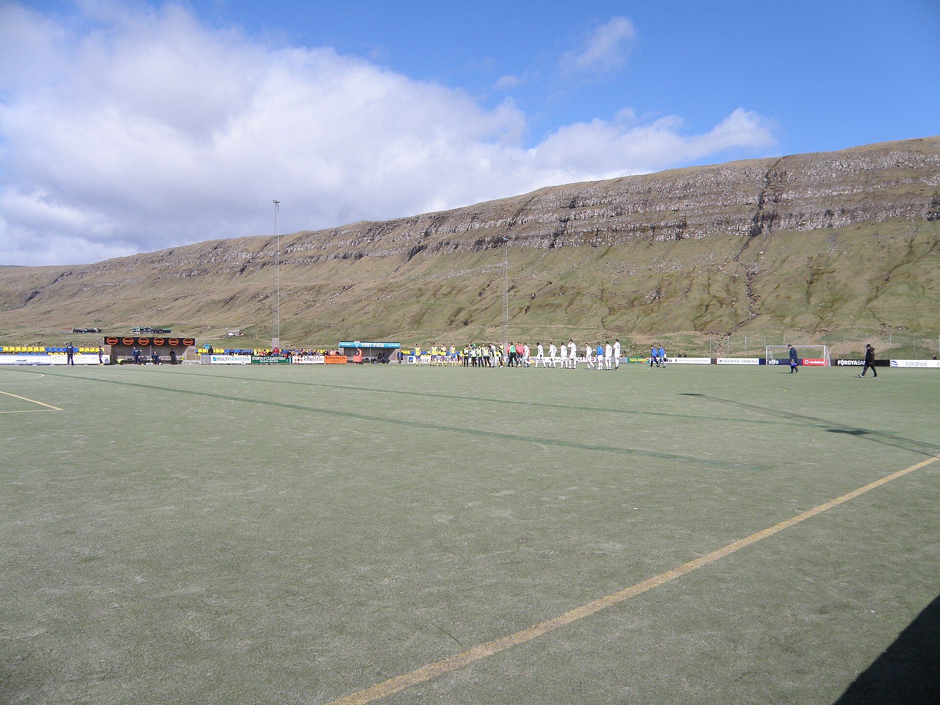 The football (soccer) stadium of B71 Sandoy is Inni í Dal, halfway between Sandur and Skopun on Sandoy island in the Faroe Islands . This photo was taken on 2 May 2010 just before the match between B71 Sandoy and FC Suðuroy in Vodafonedeildin (Premier League) started. There were no seats before 2010
