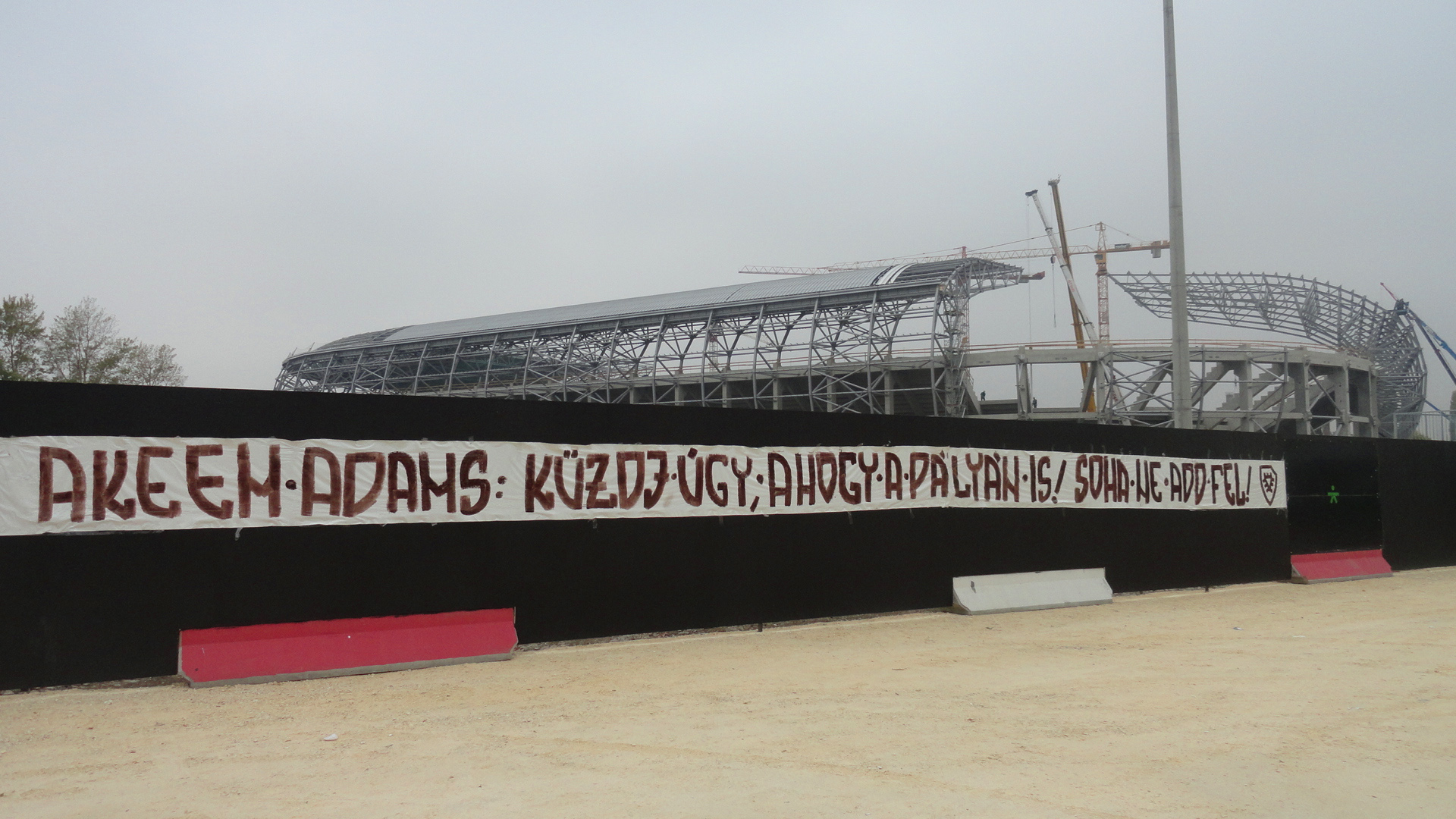 Message of the fans for hospitalized Akeem Adams at the construction site of the new Ferencváros stadium. Translation: Akeem Adams: Fight the way you do on the field! Never give up!