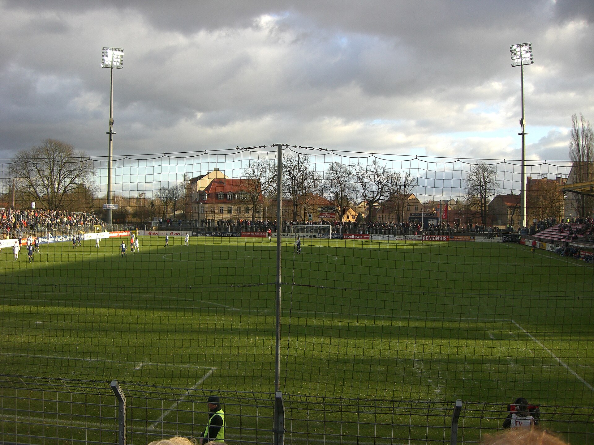 Karl Liebknecht stadium, home of German football club Babelsberg 03, in a third league match vs. Kickers Emden in Dec. 2007. The floodlight masts can be turned down halfway and usually are while no match takes place. This is to ensure the visibility of the Babelsberg Park (UNESCO world heritage site