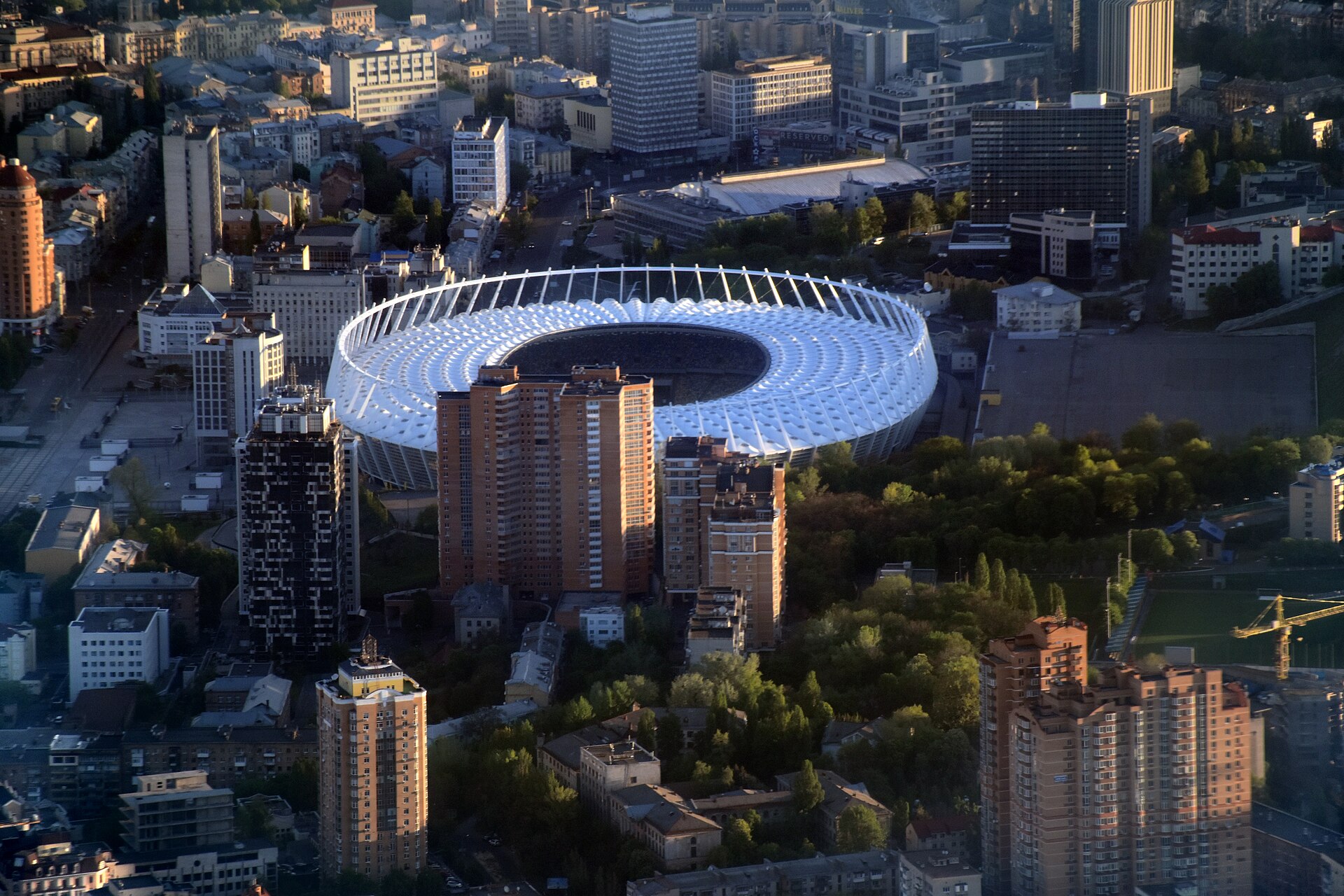 Aerial view of Olimpiyskiy National Sports Complex and buildings of historical neighbourhoods of Kiev — Cherepanova Gora and Nova Zabudova. Velyka Vasylkivska Street is visible on the left side of the picture, in the upper centre part (over the stadium) is Esplanadna Street.