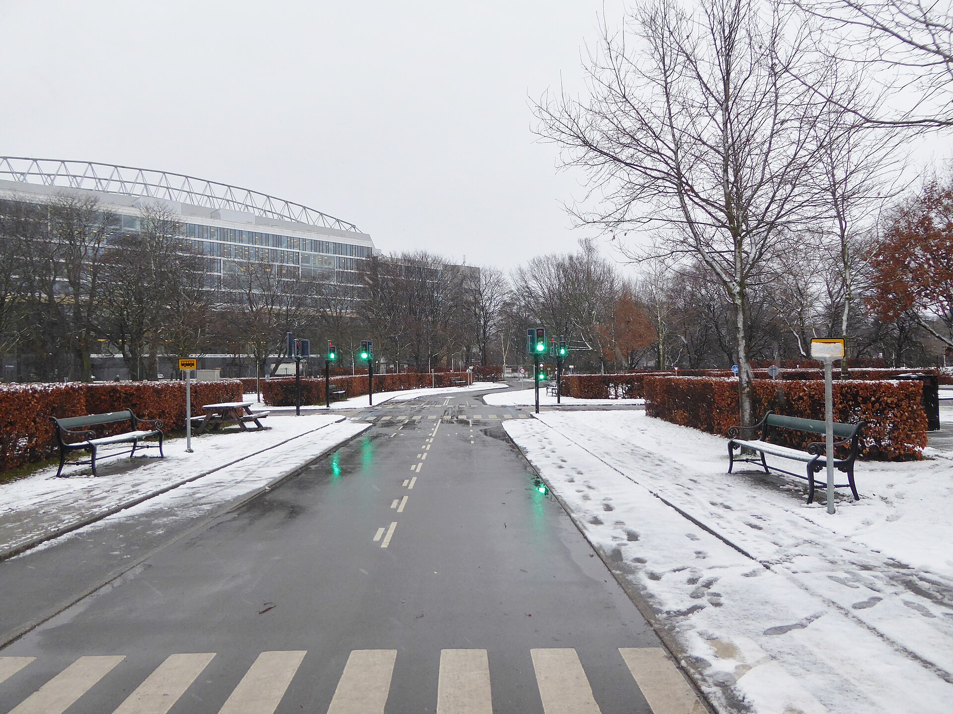 Snow at the traffic playground Trafiklegepladsen in Fælledparken in Copenhagen. In the background the national soccer stadium Parken can be seen.