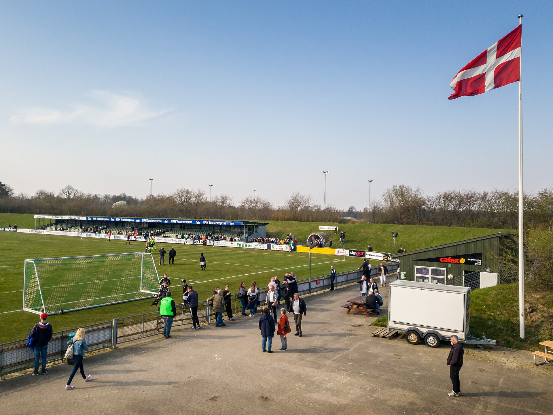 Spectators standing around near the entrance of Espelundens Idrætsanlæg after the football match between BK Avarta and Hillerød Fodbold in the Danish 2nd division (6 April 2019)