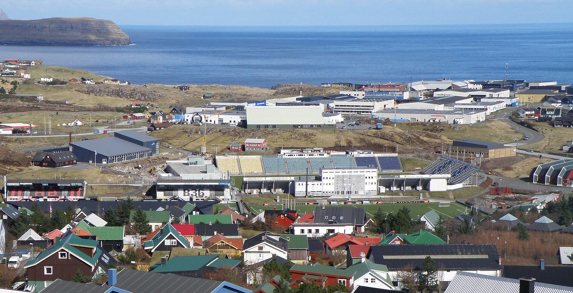 View over Tórshavn , the capital of the Faroe Islands . The sports area of Tórshavn is in the center of the photo in Gundadalur and on Hálsi. There is the Sports Hall on Nabb (also called Høllin á Hálsi). To the left on the photo, just above the football field (Ovari vøllur) is the Swimming Hall of 