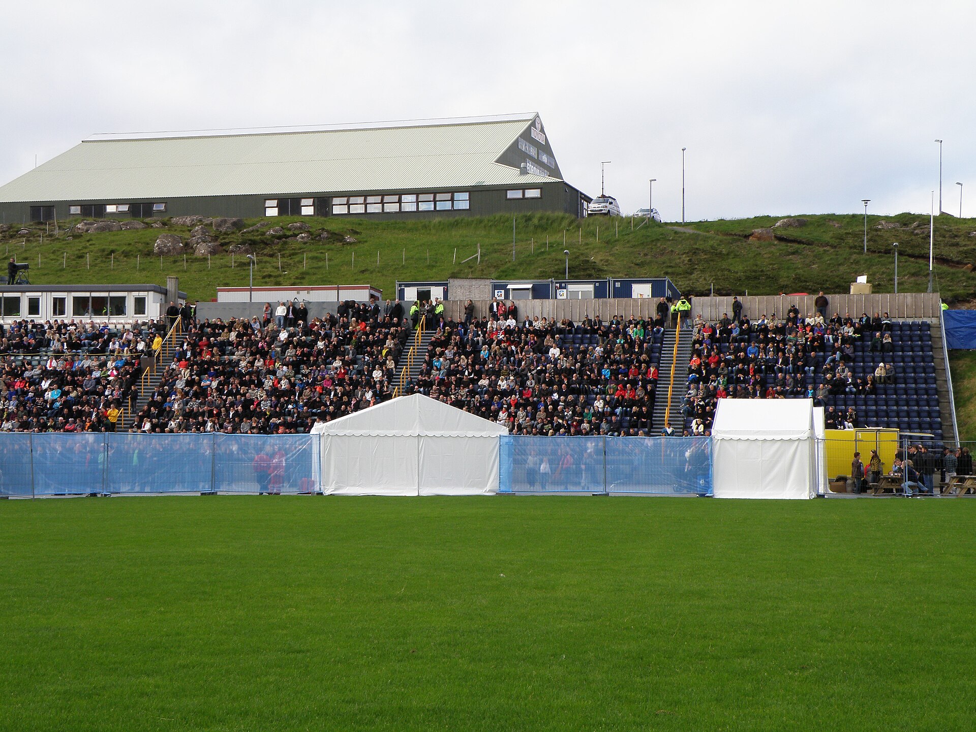The sports hall on Nabb (Høllin á Nabb) in Tórshavn is the oldest or one of the oldest sports hall in the Faroe Islands , it was built in 1970. Here it is seen from Tórsvøllur, which is one of two national football stadiums in the Faroe Islands, the other one is in Toftir. Tórsvøllur was used for an