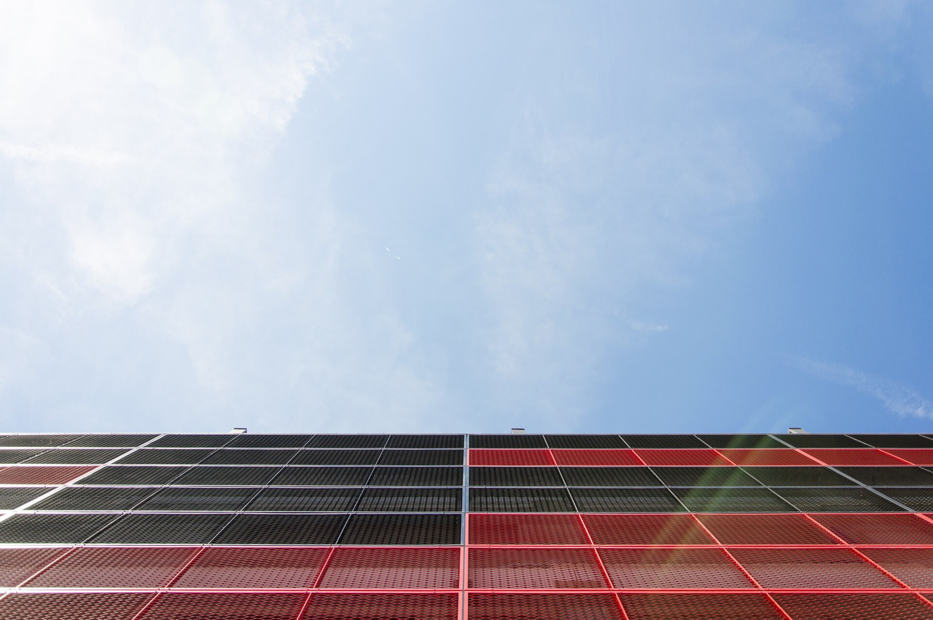 500px provided description: Slovakia 2015, CityArena Trnava [#sky ,#red ,#blue ,#sun ,#architecture ,#black ,#wall ,#slovakia ,#glare ,#minimalistic ,#Trnava ,#CityArena]