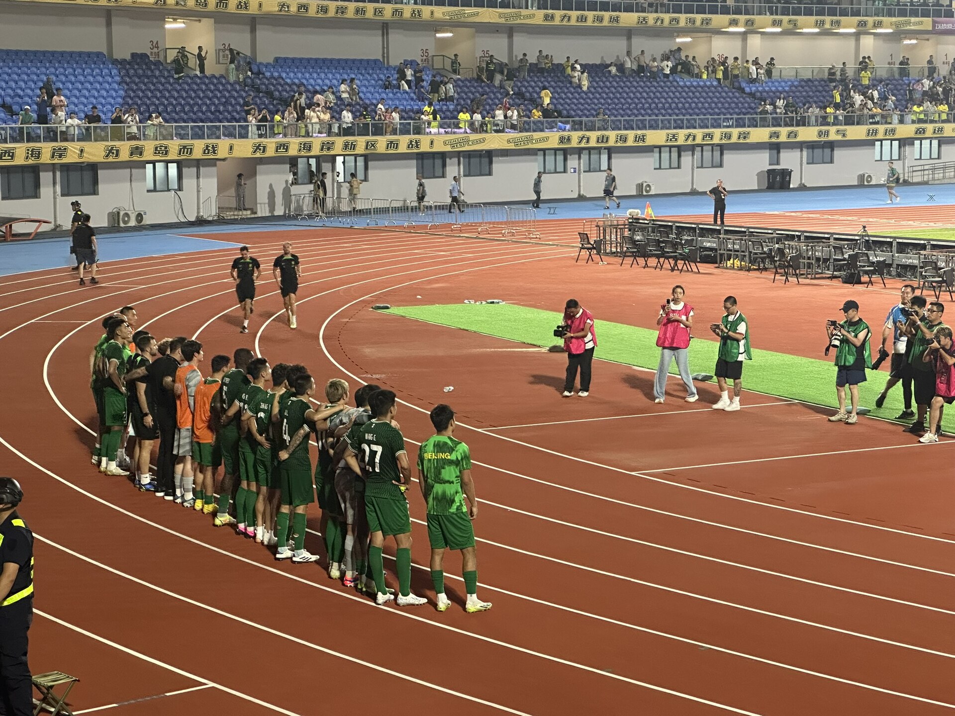 Beijing Guoan players line up for a hot afteer their game against Qingdao West Coast on 11 August 2024