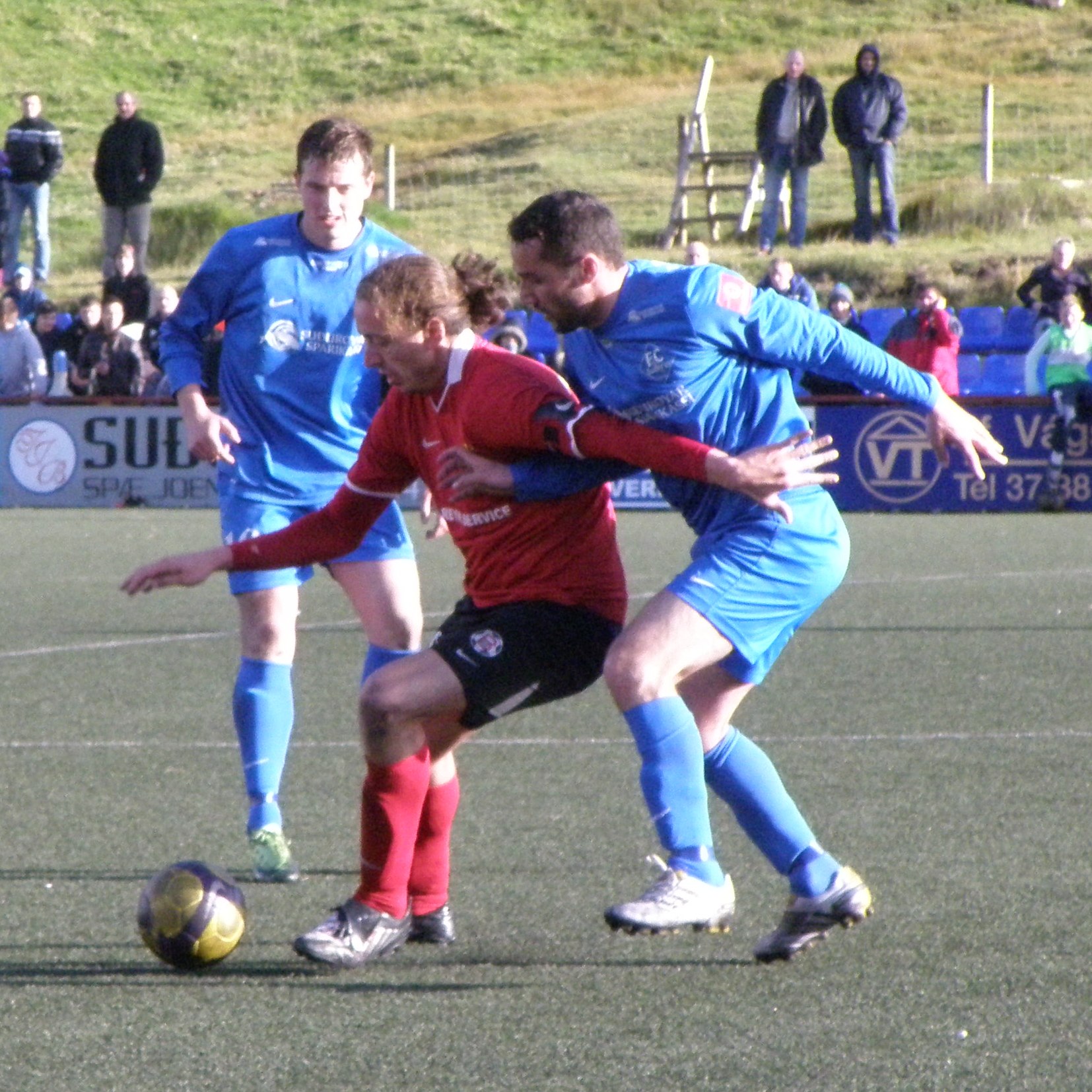 Football (soccer) match in the Faroe Islands in Vodafonedeildin (Faroe Islands Premier League) on 2 October 2010 between FC Suðuroy and B68 Toftir. The match was played on Eiðinum football field in Vágur . The players on the photo are FC Suðuroy player Jón Krosslá Poulsen (to the left in blue), B68 