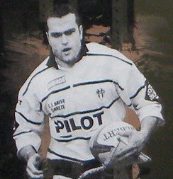 Picture of Alain Penaud wearing CA Brive jersey displayed inside Stade Amédée-Domenech