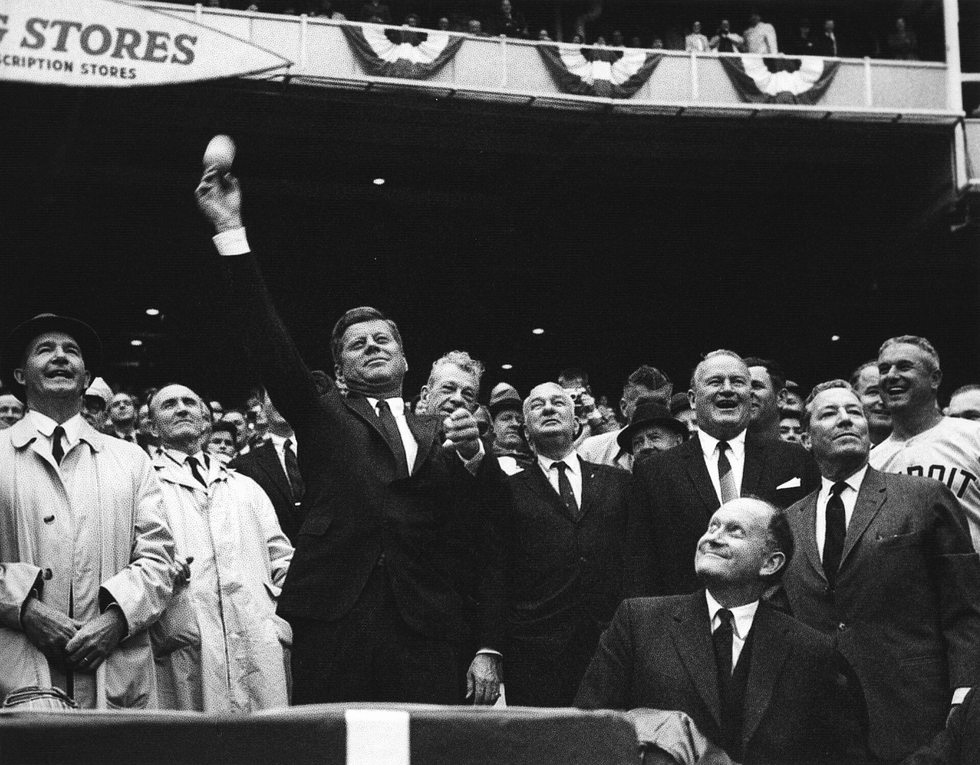 Original caption: President John F. Kennedy throws the first pitch of the 1962 baseball season. (L-R) Special Assistant to the President Dave Powers; Senator Mike Mansfield of Montana; President Kennedy; Senator Everett Dirksen of Illinois (looking over President Kennedy’s shoulder); Representative