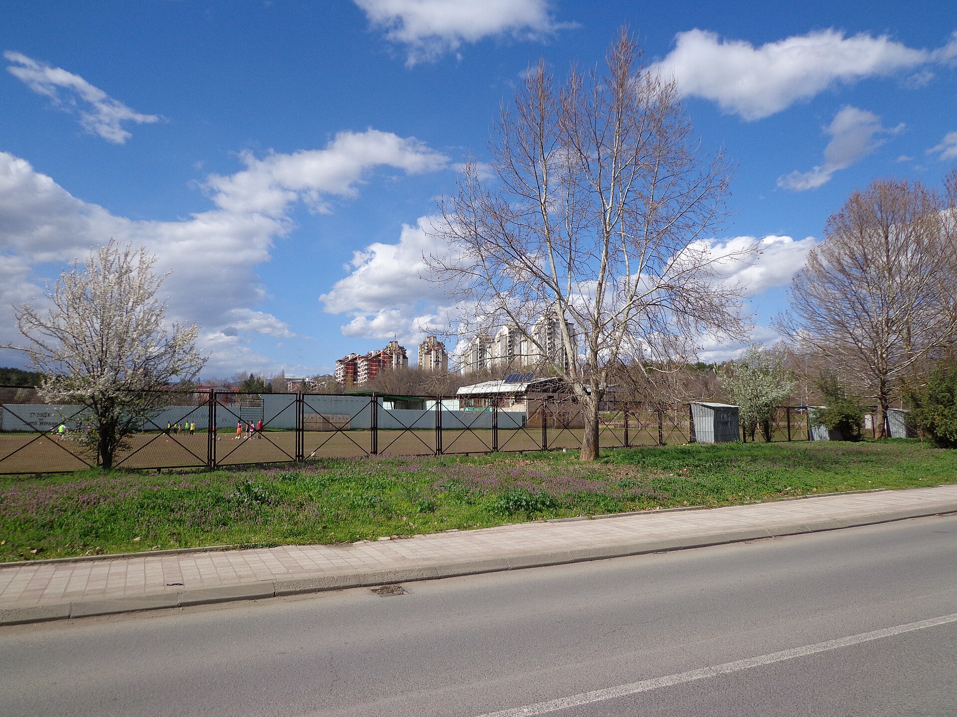 The training football field at the Avtokomanda/Železara Stadium. In the background is the Železara neighborhood, Gazi Baba Municipality.