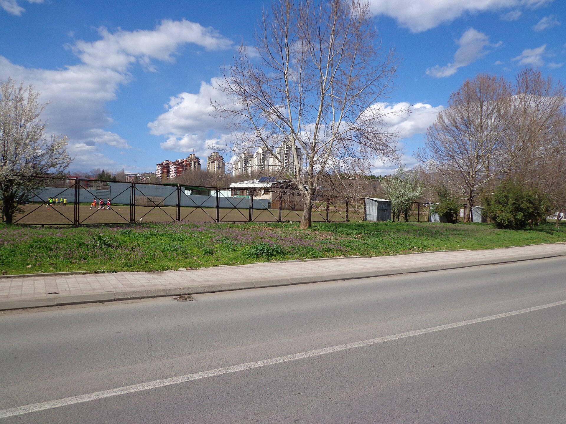 The training football field at the Avtokomanda/Železara Stadium. In the background is the Železara neighborhood, Gazi Baba Municipality.