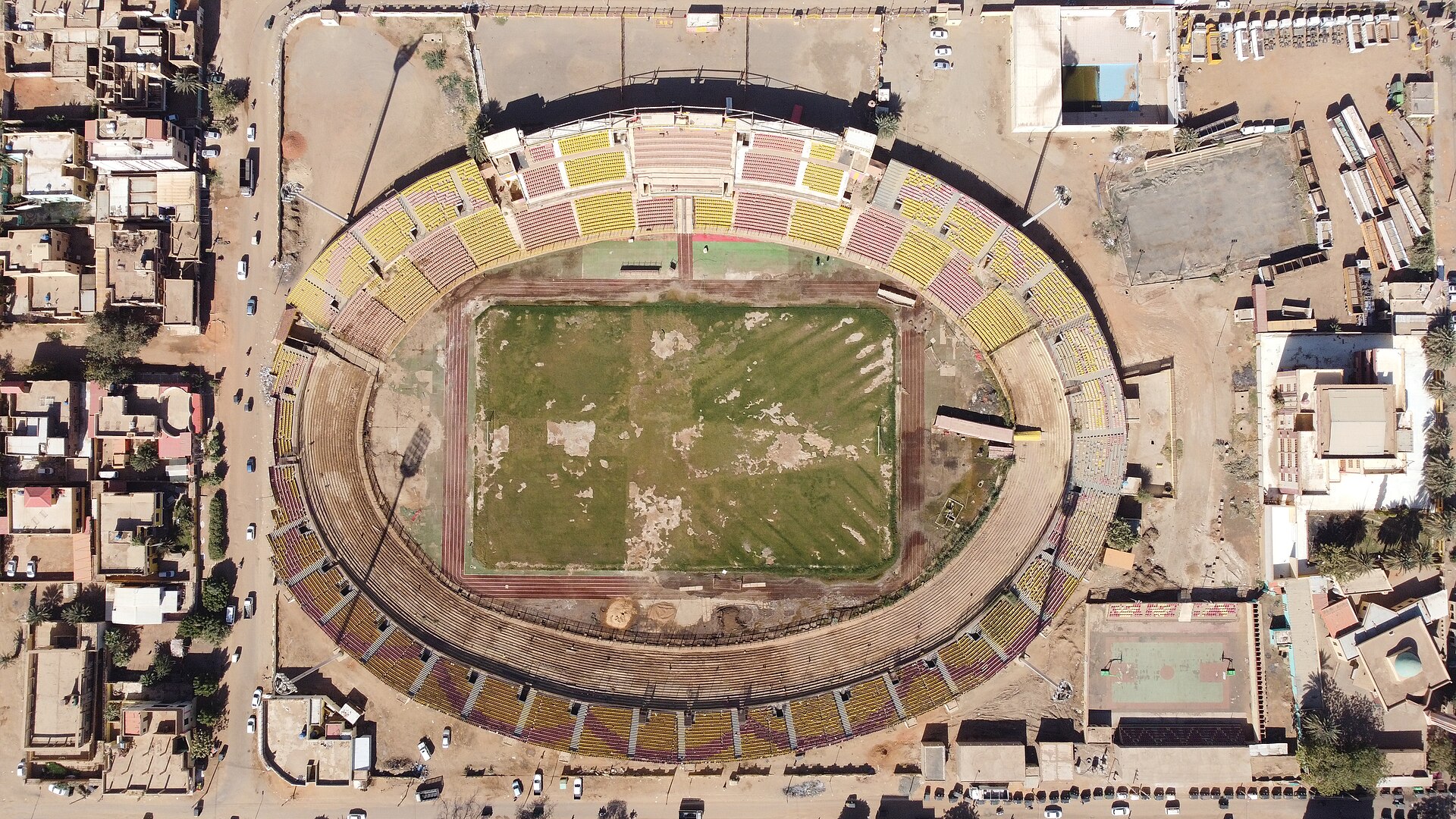 Al-Marekh Stadium, Omdurman, Sudan 1964. Designed by Abdel-Moneim Mustafa. The main concept was inspired from the use of a cost-effective method to construct a stadium that represents a landmark. The playing field level is – 4 meters while the highest level is 7 meters from the ground floor. So the