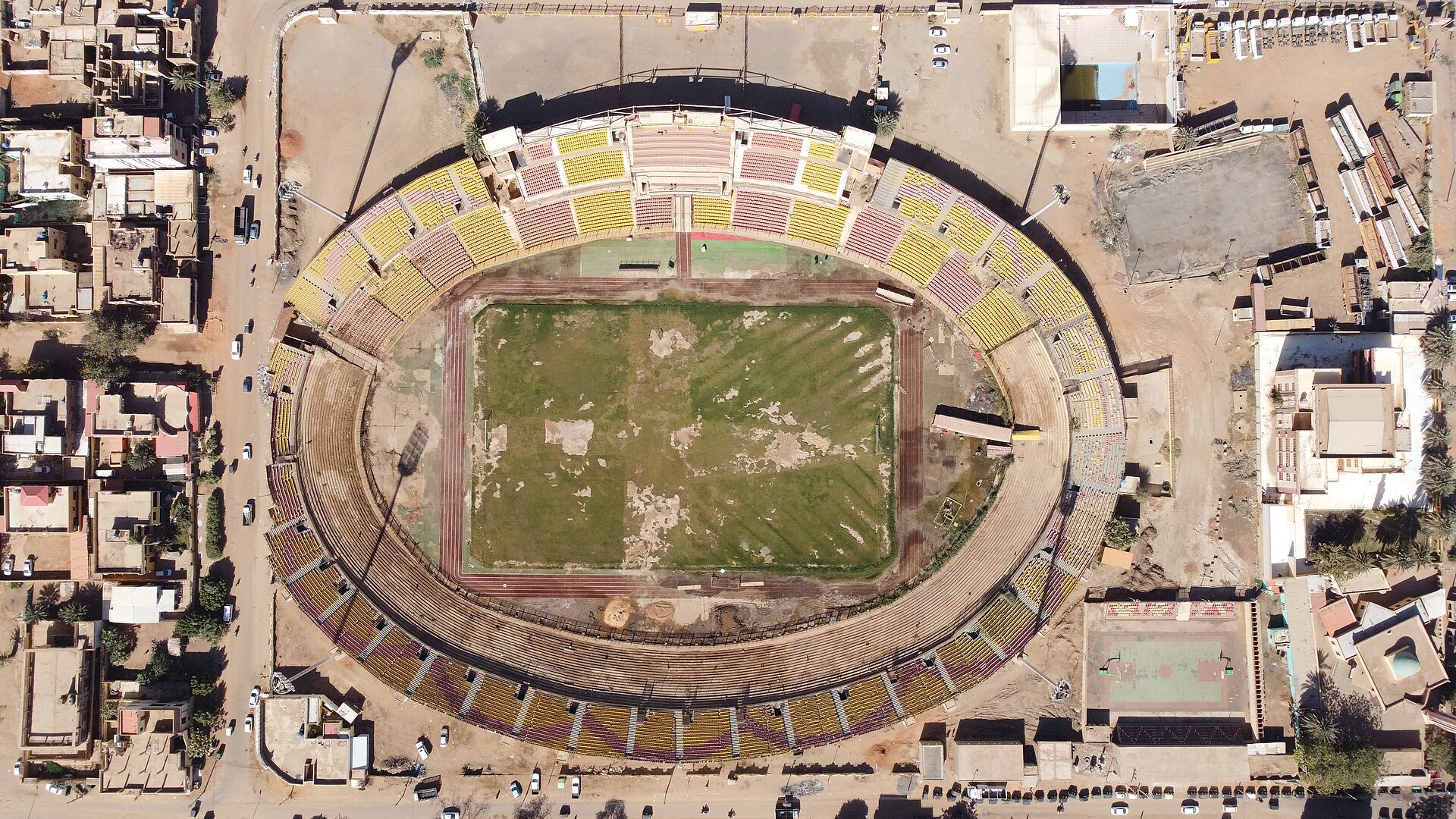 Al-Marekh Stadium, Omdurman, Sudan 1964. Designed by Abdel-Moneim Mustafa. The main concept was inspired from the use of a cost-effective method to construct a stadium that represents a landmark. The playing field level is – 4 meters while the highest level is 7 meters from the ground floor. So the