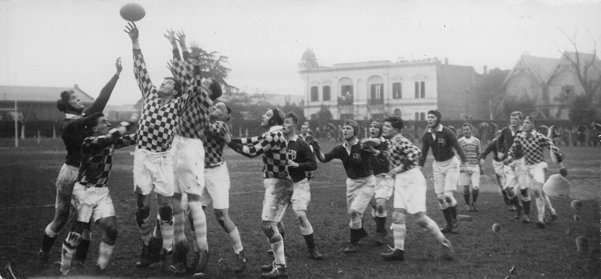 Scene from the rugby union match between the British Lions and a combined team (formed by players of GEBA and Universitario BA, in squared jerseys) as part of the British tour on Argentina. The game was played at Plaza Jewell, venue of Club Atlético del Rosario.