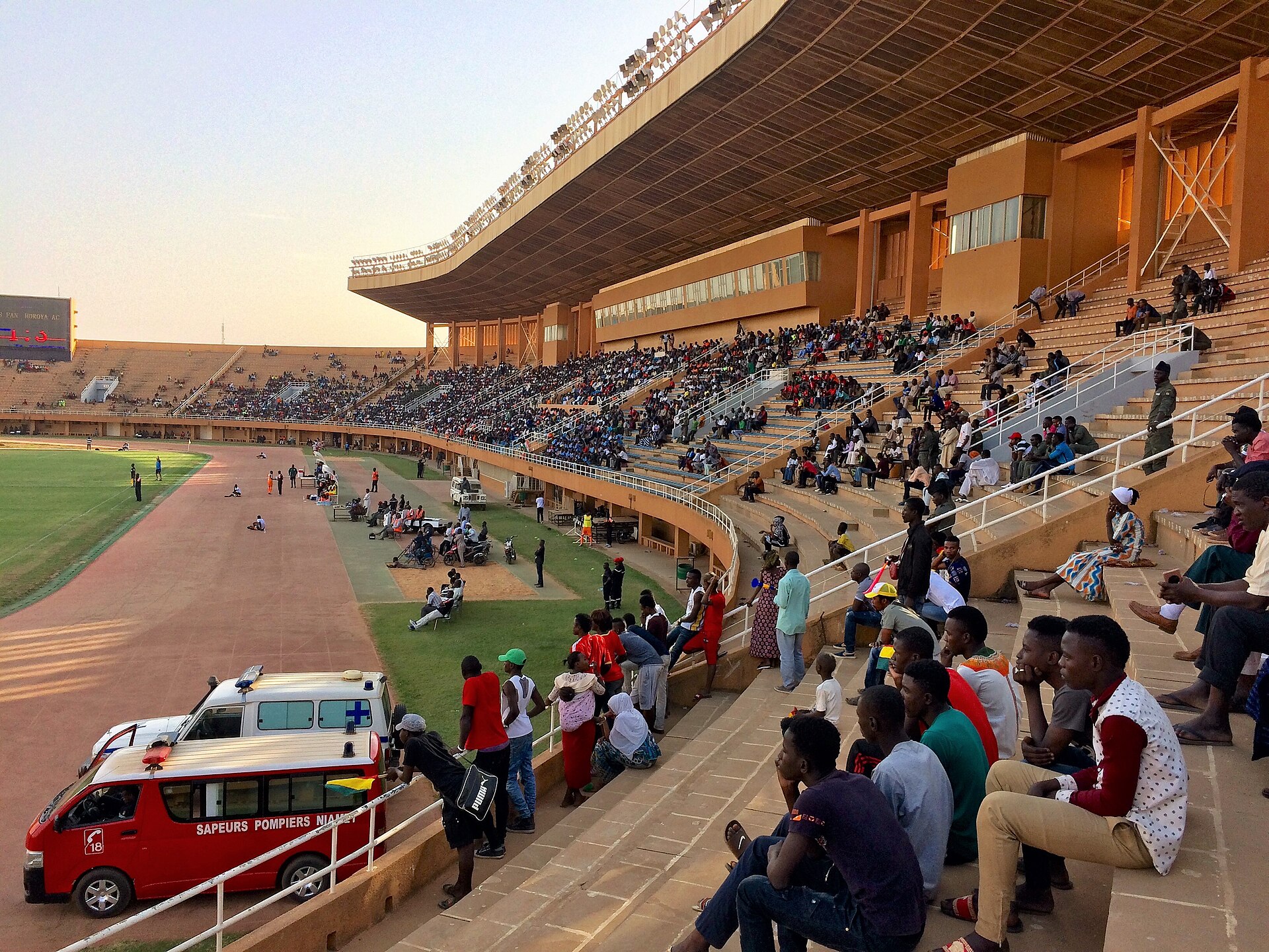 People watching a soccer match in the General Seyni Kountché Stadium in Niamey, Niger