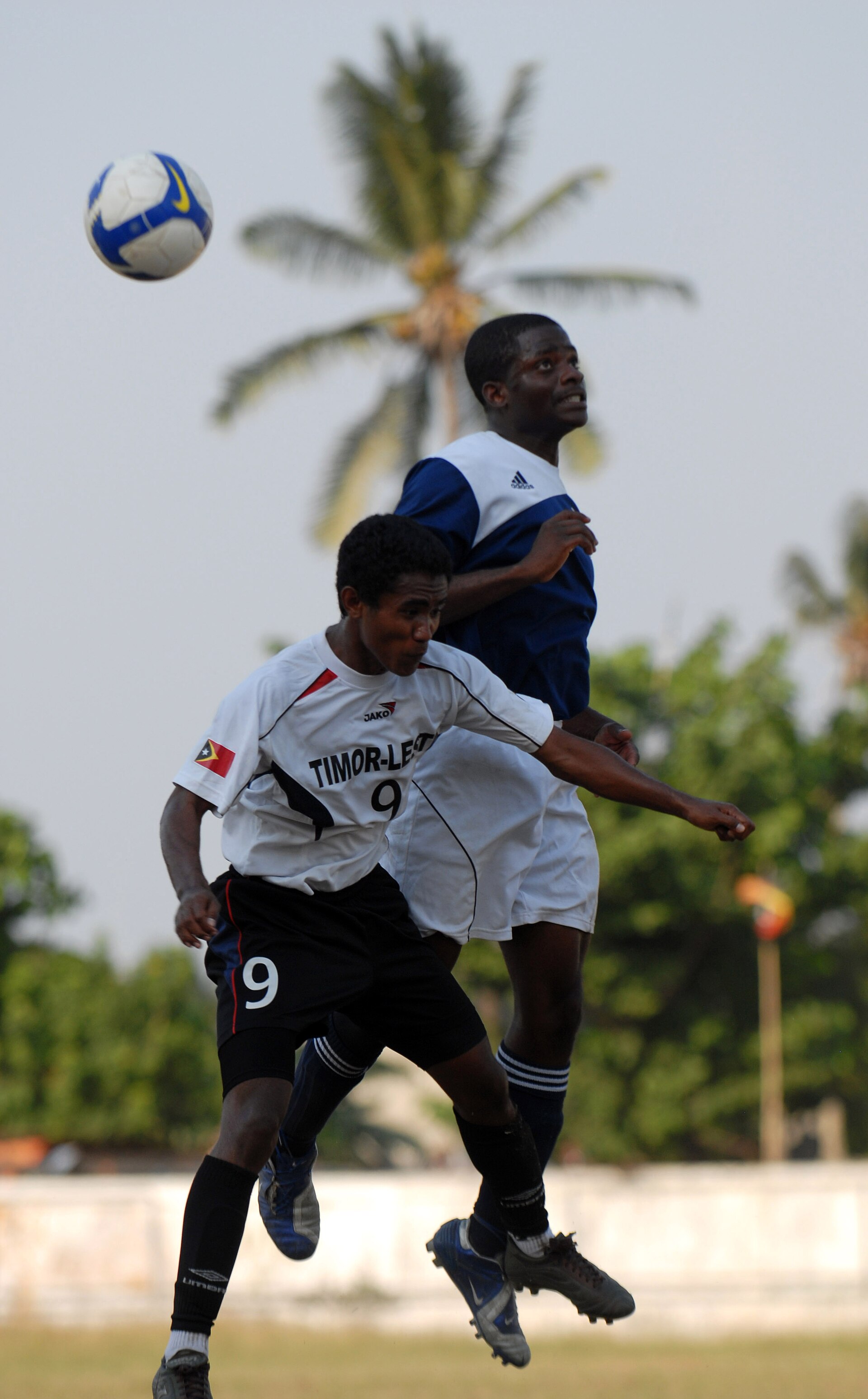 DILI, Timor-Leste (Oct. 18, 2009) A Sailor assigned to the amphibious assault ship USS Bonhomme Richard (LHD 6) and also on the ship's soccer team plays soccer with a member of the Under-Seventeen Timor-Leste National Soccer Team at Dili National Stadium. (U.S. Navy photo by Mass Communication Speci