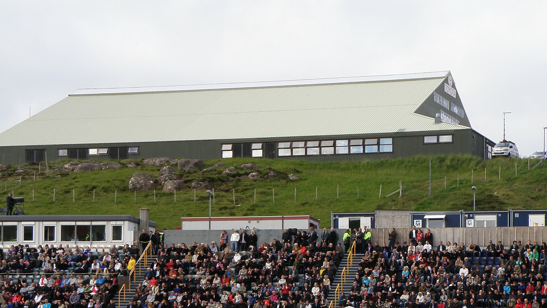 The sports hall on Nabb (Høllin á Nabb) in Tórshavn is the oldest or one of the oldest sports hall in the Faroe Islands , it was built in 1970. Here it is seen from Tórsvøllur, which is one of two national football stadiums in the Faroe Islands, the other one is in Toftir. Tórsvøllur was used for an