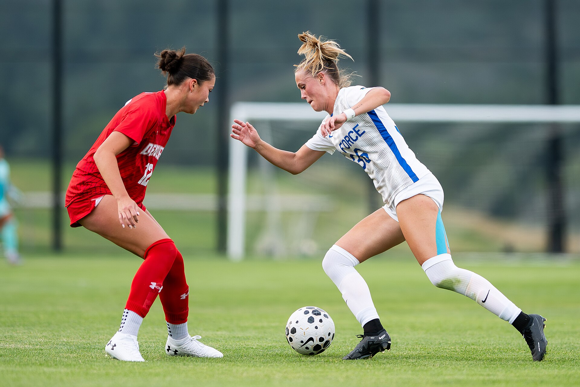 U.S. AIR FORCE ACADEMY, Colo. -- Air Force’s Kendall Rippley makes a move around Denver's Luci Vincent during a home game against University of Denver at the Academy’s Cadet Soccer Stadium in Colorado Springs, Colo., August 14, 2025. Air Force eventually lost to Denver 1-2. (U.S. Air Force photo by