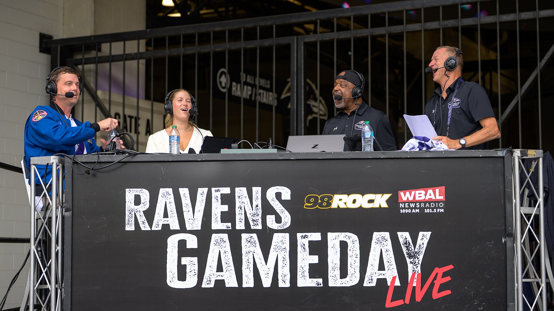 NASA astronaut and commander of the agency’s Artemis II mission, Reid Wiseman, a Baltimore native, left, joins Valerie Preactor, Kirk McEwen, and Keith Mills, right, for a WBAL radio interview prior to the start of an NFL game between the New Orleans Saints and the Baltimore Ravens at M&T Bank Stadi