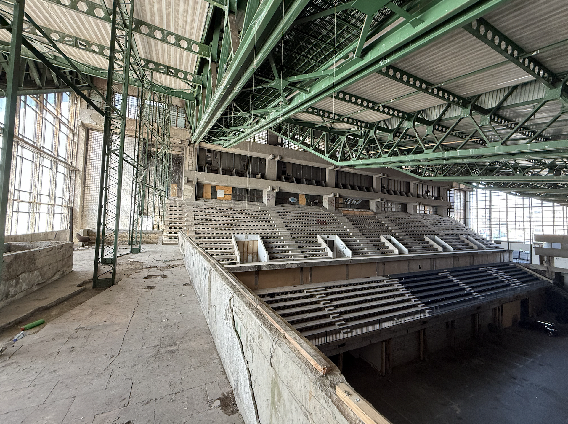 The inside of Pristina Palace of Youth and Sports being used as a car park as of 2025